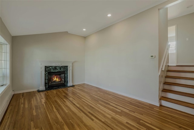 311 Atlantic, Massapequa Park, NY 11762 - unfurnished living room with wood finished floors, a fireplace, stairs, a baseboard radiator, and baseboards