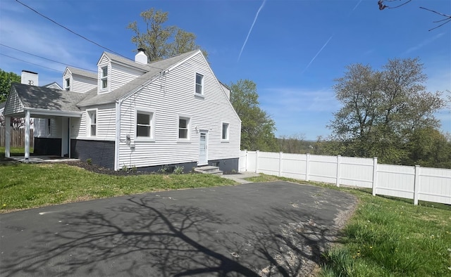 247 Osborne Hill Rd, Fishkill, NY 12524 - view of property exterior with fence, a patio, entry steps, a chimney, and a lawn