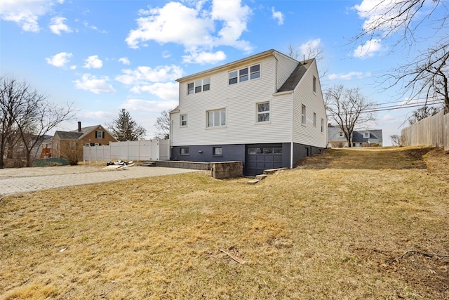 247 Osborne Hill Rd, Fishkill, NY 12524 - rear view of property featuring a yard, driveway, an attached garage, and fence
