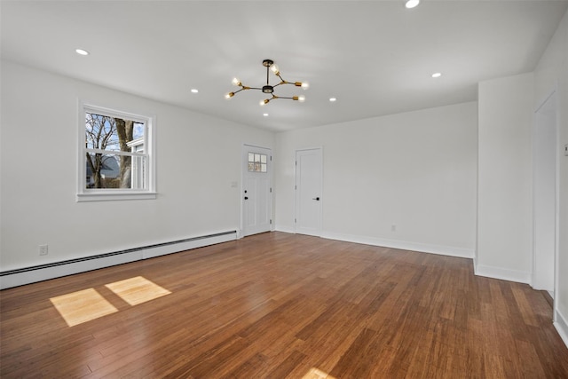 247 Osborne Hill Rd, Fishkill, NY 12524 - unfurnished living room featuring a chandelier, a wealth of natural light, baseboard heating, and wood finished floors