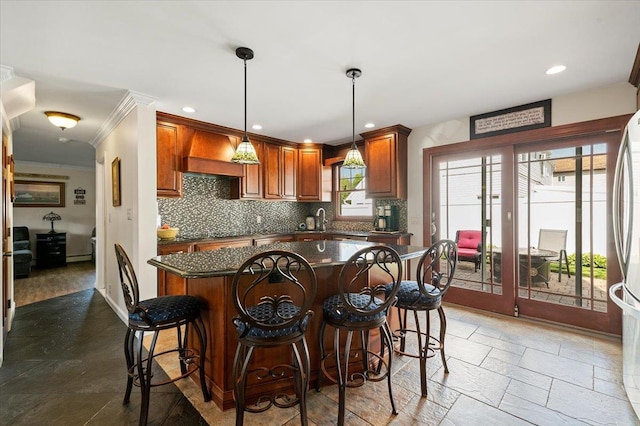 340 Martin Pl, Bethpage, NY 11714 - kitchen featuring a kitchen island, decorative backsplash, crown molding, brown cabinets, and a kitchen bar