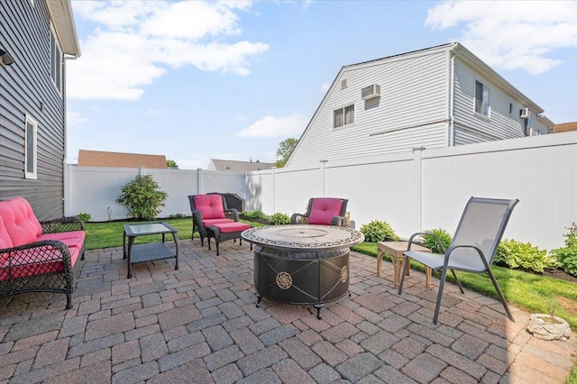 340 Martin Pl, Bethpage, NY 11714 - view of patio featuring a fire pit, a fenced backyard, and an AC wall unit