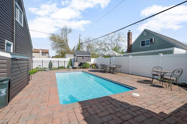 340 Martin Pl, Bethpage, NY 11714 - view of swimming pool featuring a patio, a shed, outdoor dining area, and an outdoor structure