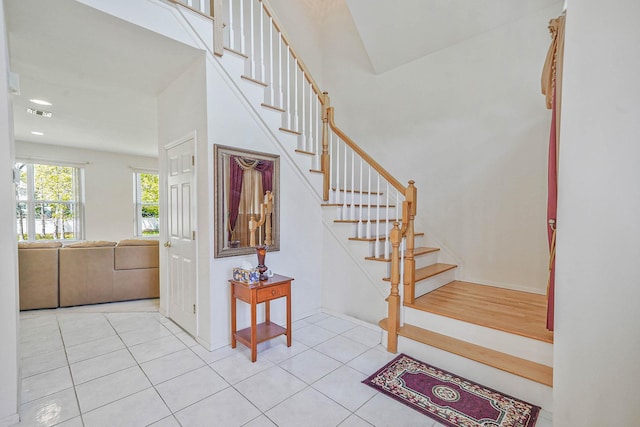 staircase featuring tile patterned floors and recessed lighting