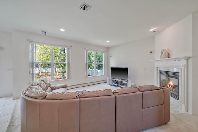 living area with a baseboard radiator, a high end fireplace, and recessed lighting