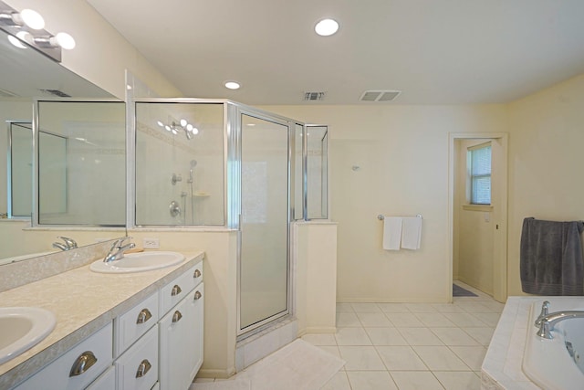 full bathroom featuring a stall shower, tile patterned flooring, recessed lighting, double vanity, and a garden tub