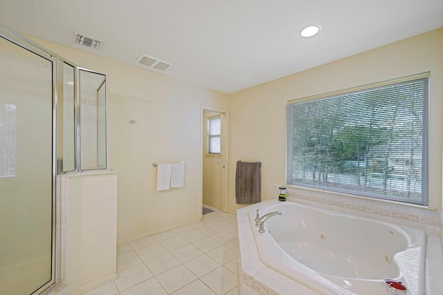 full bath featuring healthy amount of natural light, a whirlpool tub, and a shower stall