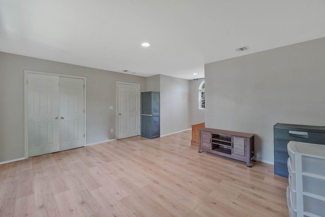 unfurnished living room with light wood-style floors, baseboards, and recessed lighting
