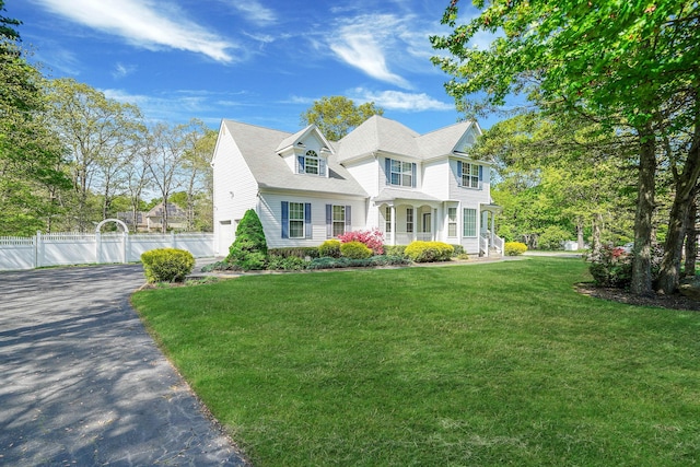 victorian home featuring an attached garage, driveway, and covered porch