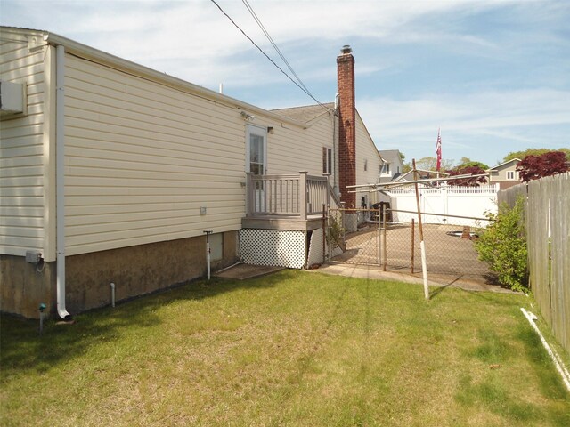 212 Wensley Ln, East Islip, NY 11730 - back of property with a chimney and a deck