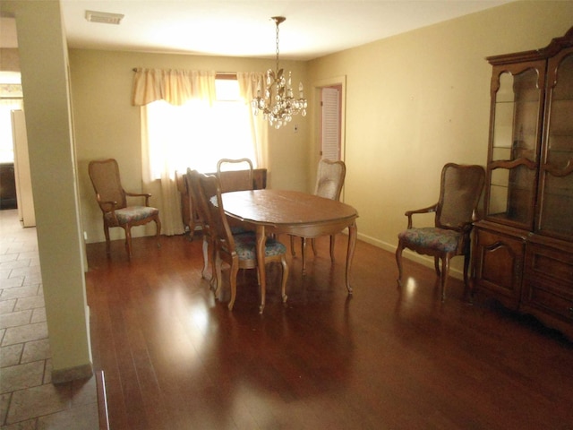 212 Wensley Ln, East Islip, NY 11730 - dining space featuring a chandelier, wood finished floors, and baseboards