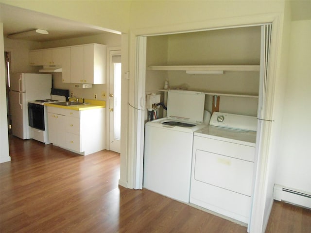 212 Wensley Ln, East Islip, NY 11730 - laundry room with washer and clothes dryer, a baseboard radiator, and dark wood-type flooring