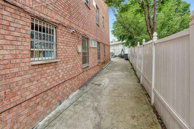 1934 Chatterton Ave, Bronx, NY 10472 - view of side of home with brick siding and fence