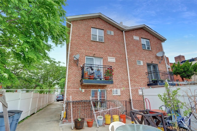 1934 Chatterton Ave, Bronx, NY 10472 - back of house with brick siding, fence, and a balcony