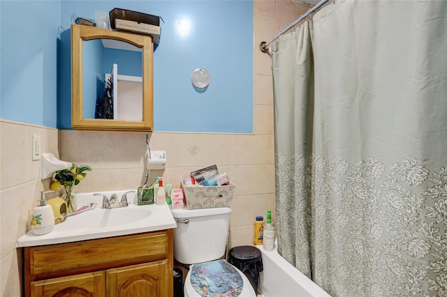 1934 Chatterton Ave, Bronx, NY 10472 - bathroom featuring tile walls, vanity, toilet, shower / tub combo with curtain, and a wainscoted wall