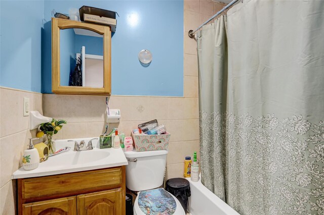 1934 Chatterton Ave, Bronx, NY 10472 - bathroom featuring tile walls, vanity, toilet, shower / bath combination with curtain, and wainscoting