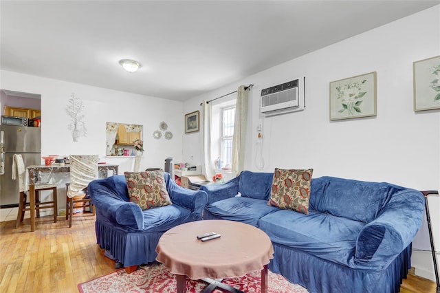 1934 Chatterton Ave, Bronx, NY 10472 - living area with a wall mounted air conditioner and light wood-style floors