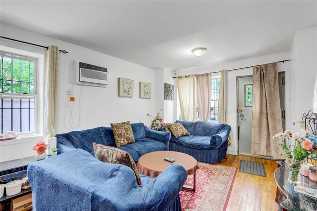 1934 Chatterton Ave, Bronx, NY 10472 - living room featuring a wall mounted AC and wood finished floors