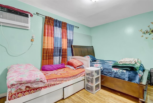 1934 Chatterton Ave, Bronx, NY 10472 - bedroom with wood finished floors and an AC wall unit