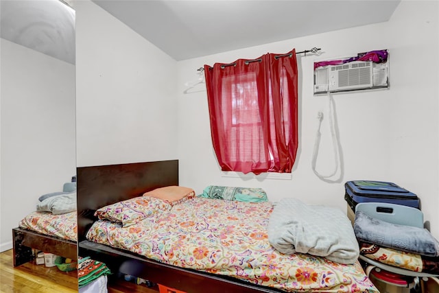 1934 Chatterton Ave, Bronx, NY 10472 - bedroom with wood finished floors, a wall mounted air conditioner, and vaulted ceiling