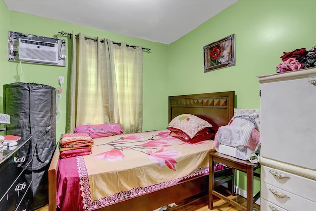 1934 Chatterton Ave, Bronx, NY 10472 - bedroom featuring a wall mounted air conditioner and wood finished floors