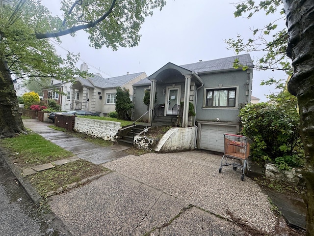 548 S 10th Ave, Mount Vernon, NY 10550 - view of front of house featuring concrete driveway, stucco siding, and a garage