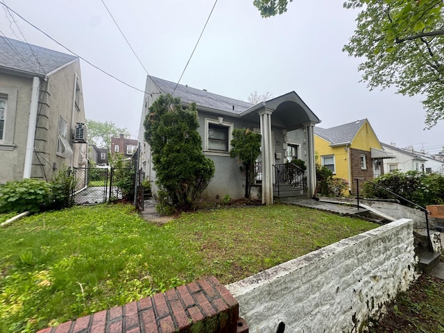 548 S 10th Ave, Mount Vernon, NY 10550 - view of front facade with a gate, fence, a residential view, stucco siding, and a front lawn