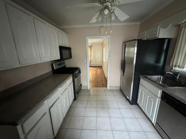 548 S 10th Ave, Mount Vernon, NY 10550 - kitchen with a sink, dark countertops, white cabinets, appliances with stainless steel finishes, and ornamental molding