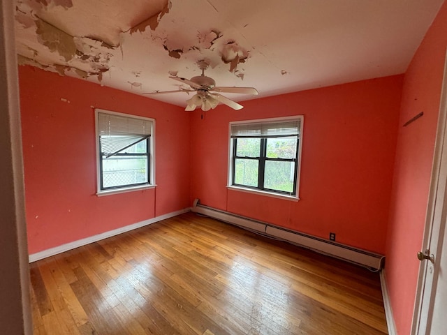 548 S 10th Ave, Mount Vernon, NY 10550 - unfurnished room featuring a baseboard radiator, wood-type flooring, and plenty of natural light