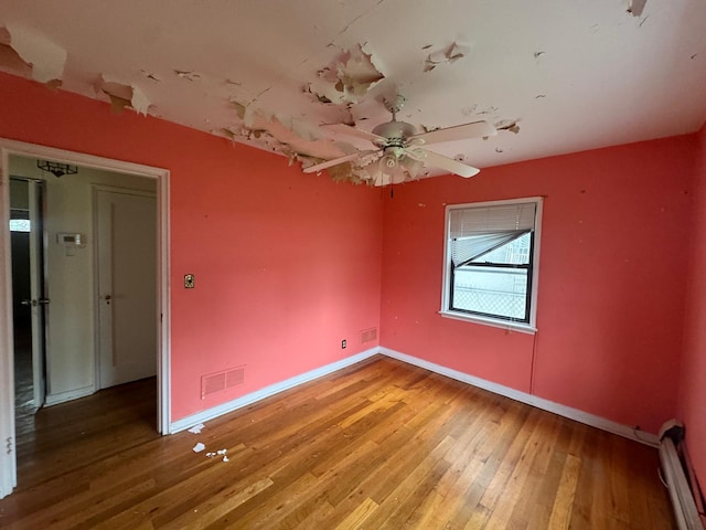 548 S 10th Ave, Mount Vernon, NY 10550 - unfurnished room featuring baseboards, a baseboard radiator, light wood-style flooring, and visible vents