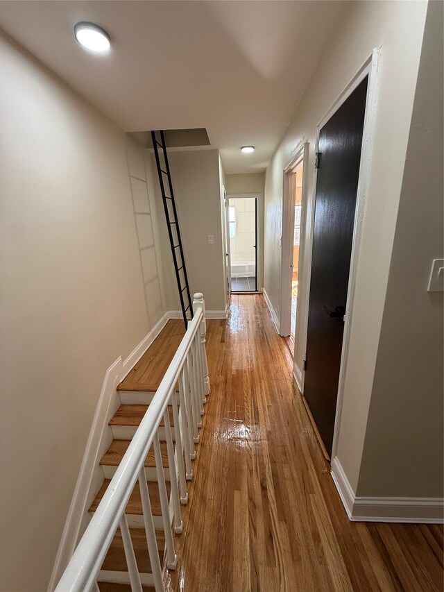 3106 Eastchester Rd, Bronx, NY 10469 - hall featuring baseboards, hardwood / wood-style floors, and stairway