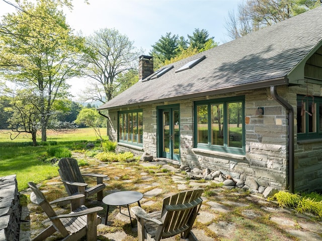 11 Louie Way, Woodstock, NY 12498 - back of house with stone siding, a shingled roof, and a chimney