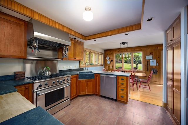 11 Louie Way, Woodstock, NY 12498 - kitchen with stainless steel appliances, a sink, a peninsula, brown cabinets, and island range hood