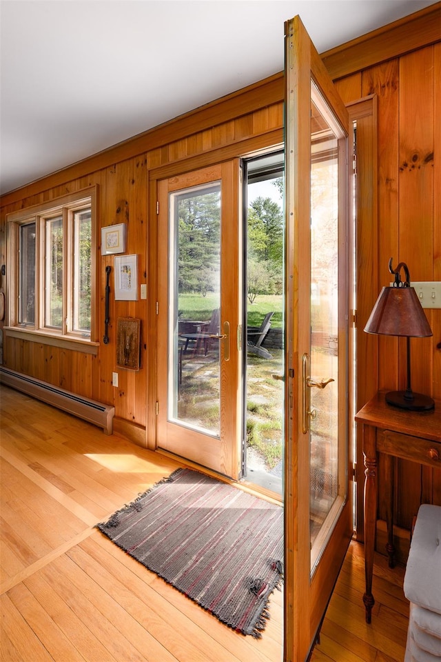 11 Louie Way, Woodstock, NY 12498 - entryway featuring a baseboard radiator, healthy amount of natural light, wood walls, and wood finished floors