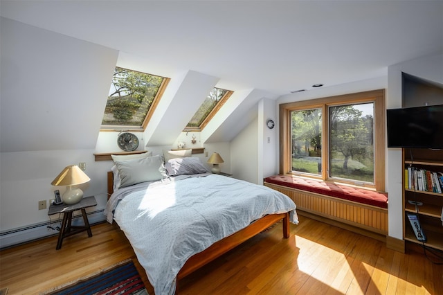 11 Louie Way, Woodstock, NY 12498 - bedroom featuring radiator, a skylight, hardwood / wood-style floors, vaulted ceiling, and a baseboard radiator