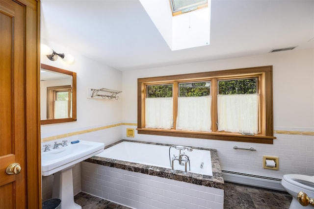 11 Louie Way, Woodstock, NY 12498 - bathroom with a baseboard radiator, a skylight, a garden tub, toilet, and tile walls