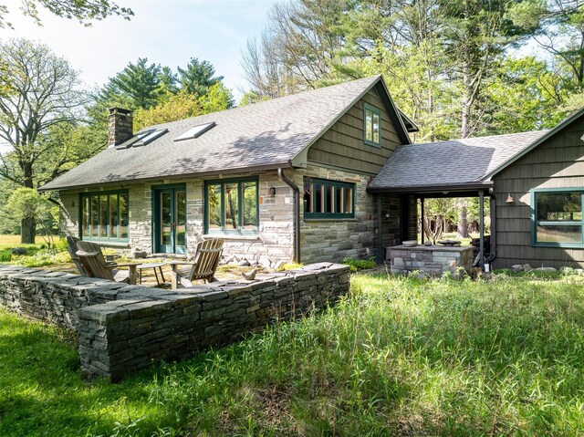 11 Louie Way, Woodstock, NY 12498 - rear view of house with a chimney, roof with shingles, stone siding, and a patio