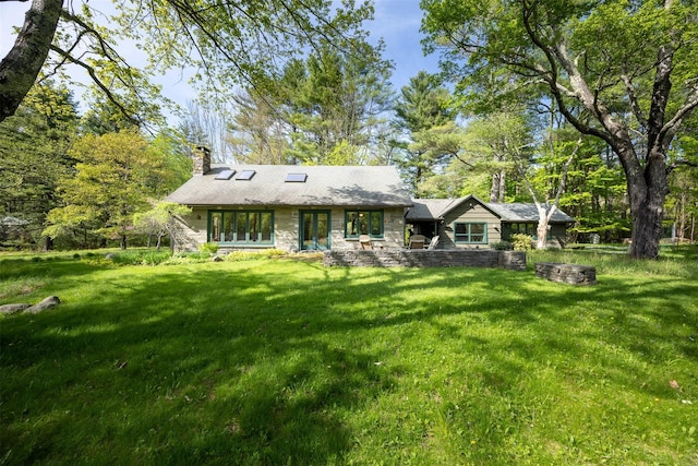 11 Louie Way, Woodstock, NY 12498 - back of property with a chimney, a lawn, and stone siding