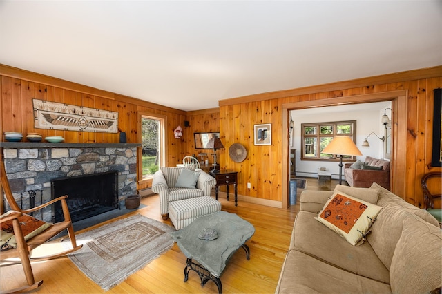 11 Louie Way, Woodstock, NY 12498 - living area with healthy amount of natural light, wood walls, light wood-type flooring, a fireplace, and a baseboard heating unit