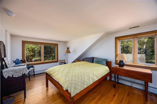 11 Louie Way, Woodstock, NY 12498 - bedroom featuring a baseboard heating unit, wood finished floors, and a baseboard radiator