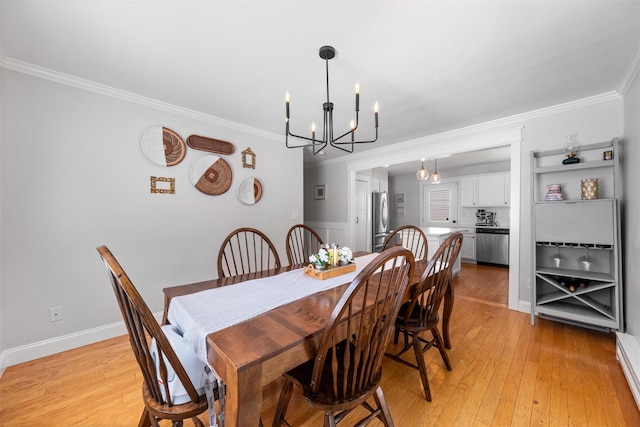 32 Lafayette Ave, Beacon, NY 12508 - dining space with a chandelier, crown molding, and light wood-style flooring