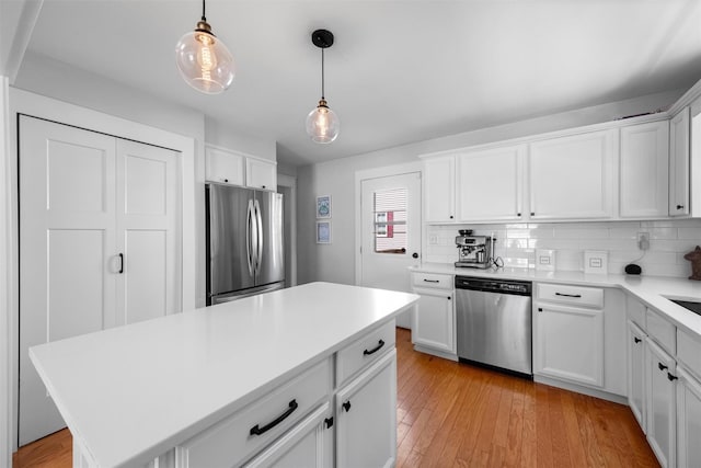 32 Lafayette Ave, Beacon, NY 12508 - kitchen with stainless steel appliances, light countertops, decorative backsplash, and light wood finished floors