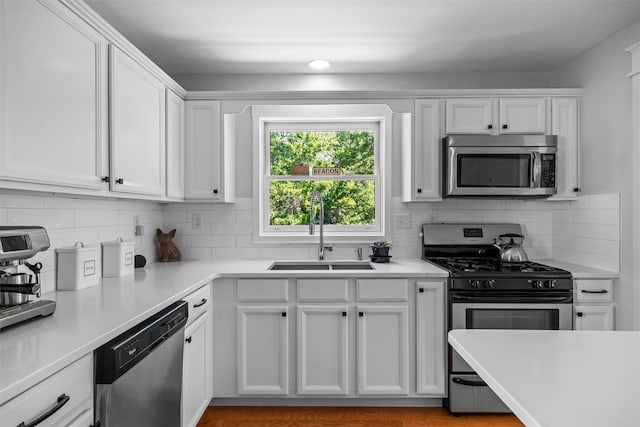 32 Lafayette Ave, Beacon, NY 12508 - kitchen with stainless steel appliances, white cabinets, light countertops, and decorative backsplash