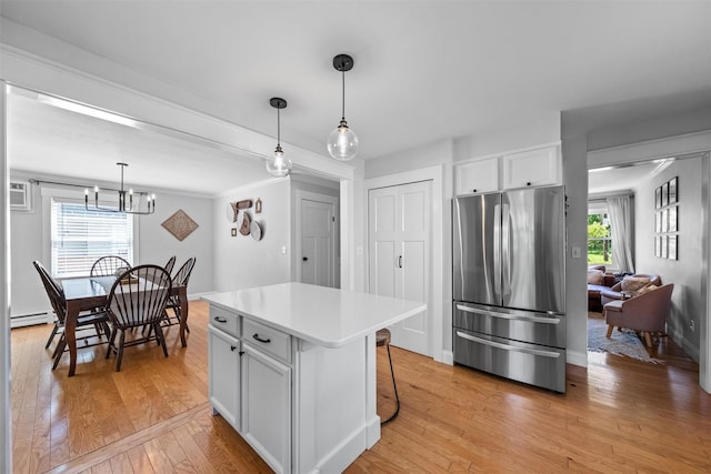 32 Lafayette Ave, Beacon, NY 12508 - kitchen featuring freestanding refrigerator, baseboard heating, light wood finished floors, light countertops, and a chandelier