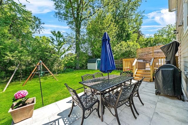 32 Lafayette Ave, Beacon, NY 12508 - view of patio with outdoor dining area, a shed, grilling area, a playground, and view of wooded area