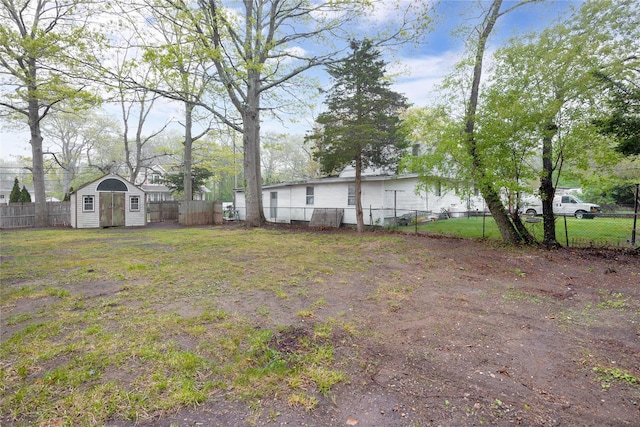 fenced backyard with a shed and an outbuilding
