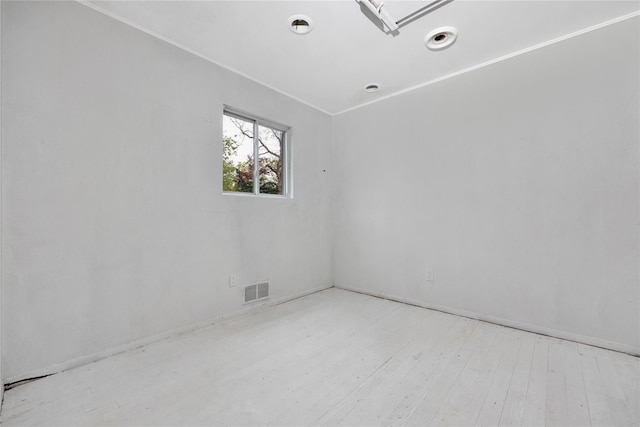 spare room featuring wood finished floors