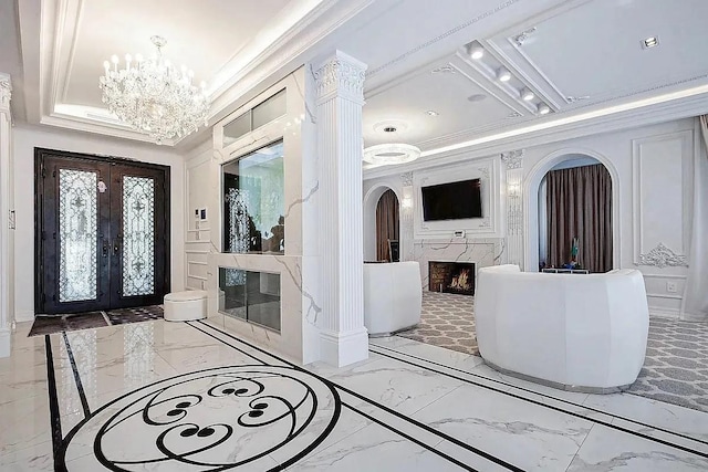 interior space with french doors, marble finish floor, a fireplace, and arched walkways