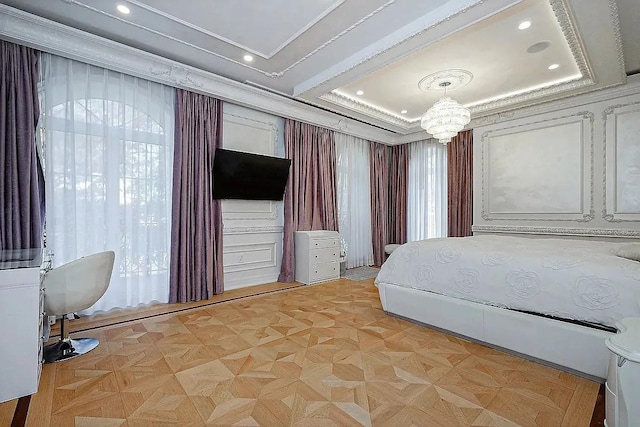 bedroom featuring a chandelier, a raised ceiling, and recessed lighting