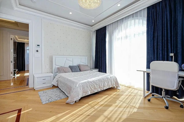 bedroom with crown molding and light wood-type flooring